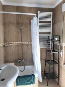 a bathroom with a bath tub and a sink at Primera línea in Castro-Urdiales +22 photos