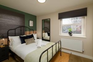 a bedroom with a bed and a window at Gad Suite by Koya Homes - Cardiff City Centre Location!! 2 En-suites in Cardiff