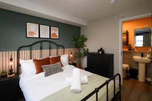 een slaapkamer met een groot bed en een badkamer bij Gad Suite by Koya Homes - Cardiff City Centre Location!! 2 En-suites in Cardiff