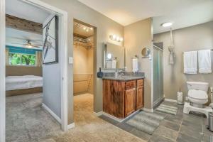 a bathroom with a sink and a toilet and a bed at Family Oasis Offices Home Gym Fenced Yard in Colorado Springs