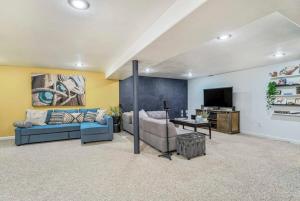 a living room with a couch and a tv at Family Oasis Offices Home Gym Fenced Yard in Colorado Springs