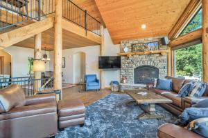 a living room with a couch and a fireplace at 5BR Family Mountain Cabin Hot Tub & Gaming Garage in Woodland Park