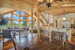 a dining room and living room with a table and chairs at 5BR Family Mountain Cabin Hot Tub & Gaming Garage in Woodland Park