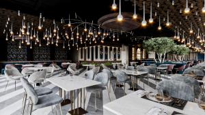 a restaurant with white tables and chairs and chandeliers at RENEX HOTELS in Antalya