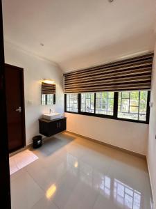 a bathroom with a sink and a large window at Luxe Hotel Thekkady in Thekkady