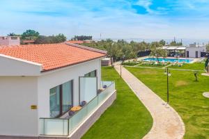 a balcony of a house with a view of a park at Assos Altın Hotel in Behramkale