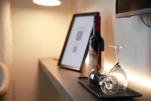 a bottle of wine and a glass on a counter at Hotell Conrad in Karlskrona