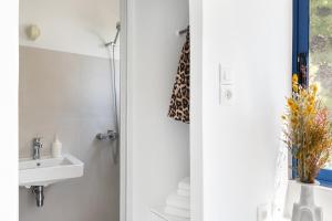a bathroom with a sink and a shower at Renovated Seaside Cabin in Sounio in Sounio