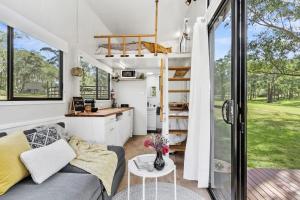 a tiny house with a kitchen and a living room at Azaltie in Kangaroo Valley
