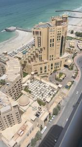 an aerial view of a hotel and the beach at F30,R3,Sunrise on the beach,1room inside 3bedroom apartment,(separate washroom outside) in Ajman 