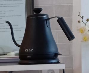 a black tea kettle sitting on top of a table at Simple Kuta Bedroom in Denpasar
