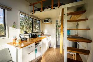 a kitchen in a tiny house with a counter top at Tiny House Farmstay at Dreams Alpaca Farm - A Windeyer Outback Experience in Windeyer