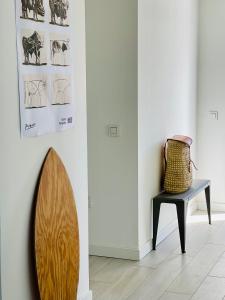 a room with a chair and a surfboard on a wall at CASA MIRABEL in Villaverde