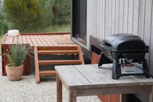 a grill sitting on a table next to a picnic table at Tiny Nanook - Kanimbla Valley in Kanimbla