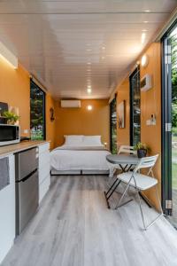 a bedroom with a bed and a table and chairs at Tiny House Big View in Boneo