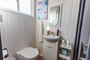 a small bathroom with a sink and a toilet at Little Magic on Magic Mountain in Coolangatta