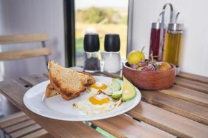 a plate of eggs and toast on a table at Farm Tiny in Braidwood