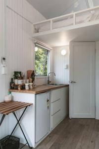 a kitchen with a counter and a sink and a window at Kookaburra Cabin in Palmwoods