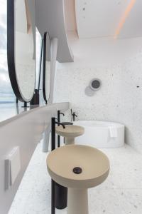 a bathroom with a sink and a bath tub at Vilnius TV Tower Apartments DEBESYS in Vilnius
