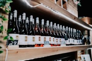 a bunch of bottles of wine on a shelf at Little Baxter in Collector