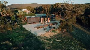 an aerial view of a house with a swimming pool at Farm Stay at Sheltered Paddock 