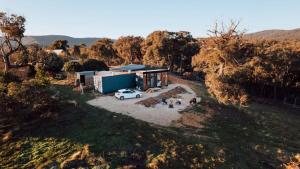 an aerial view of a house with a car parked in front at Farm Stay at Sheltered Paddock 