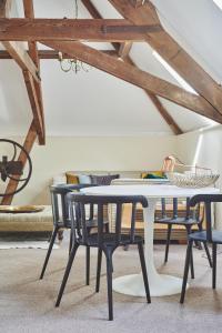 a dining room with a table and chairs at Hidden Hayloft in Holmesfield