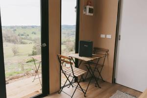 a room with a desk and a laptop on a table at Rose Hill in Neerim South