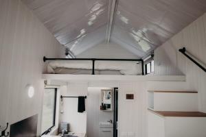 a small room with a bunk bed on the ceiling at Rosewood Mac in Macclesfield