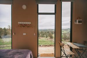 a room with an open door with a view of a field at Rose Hill in Neerim South