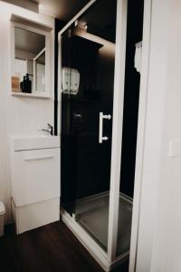 a bathroom with a glass shower and a sink at Rosewood Mac in Macclesfield