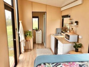 a small kitchen with a sink and a microwave at On the Rocks in Lismore