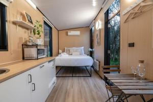 a kitchen and a bedroom with a bed in a room at Prunus Hideaway 