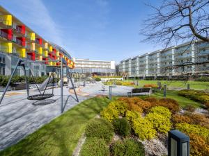 a playground in front of a building at Aquarius Kołobrzeg in Kołobrzeg