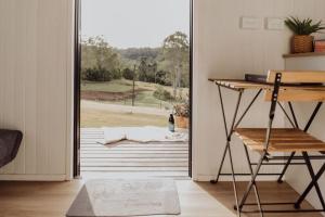 an open door with a view of a yard at Hill Creek Tiny House in Perwillowen