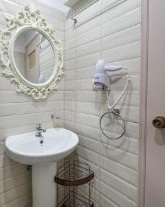 a bathroom with a sink and a mirror at Fantastic Matala 1 in Matala