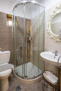 a bathroom with a shower and a toilet and a sink at Fantastic Matala 1 in Matala