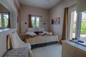 a small bedroom with a bed and a window at Fantastic Matala 1 in Matala