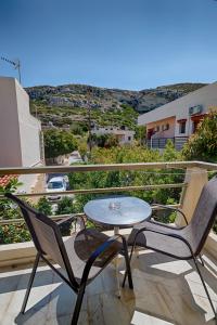 a table and chairs on a balcony with a view at Fantastic Matala 1 in Matala