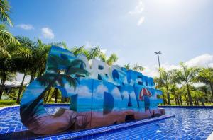 a pool at a resort with a water slide at Fermont 32 in Praia Grande