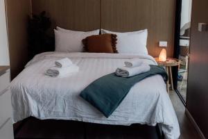 a bedroom with a bed with towels on it at Hidden Camp Pie Creek in Gympie