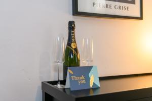 una bottiglia di champagne e un cartello di ringraziamento su un tavolo di Joseph Suite by Koya Homes a Barry