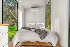 a bedroom with a bed and a large window at Montara Views 1 in Ararat