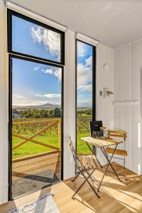 a room with a table and chairs and a large window at Montara Views 1 in Ararat