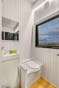 a bathroom with a toilet and a sink and a window at Montara Views 1 in Ararat
