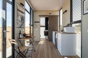 a kitchen with a counter and a table and some windows at Maluridae Sunset Views in Lawrence