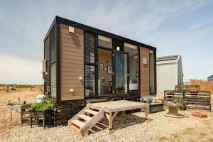 a tiny house with a bench and a table at Maluridae Sunset Views in Lawrence