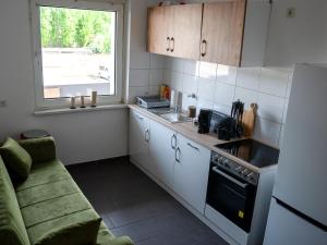 a small kitchen with a sink and a stove at SR24 - Wohnung in Duisburg 4 in Duisburg