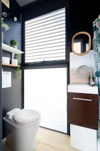 a bathroom with a toilet and a sink at Tiny Divine Farmstay in Korweinguboora