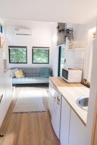 a kitchen with a couch in a tiny house at Fig Tree Cottage in Darlington
